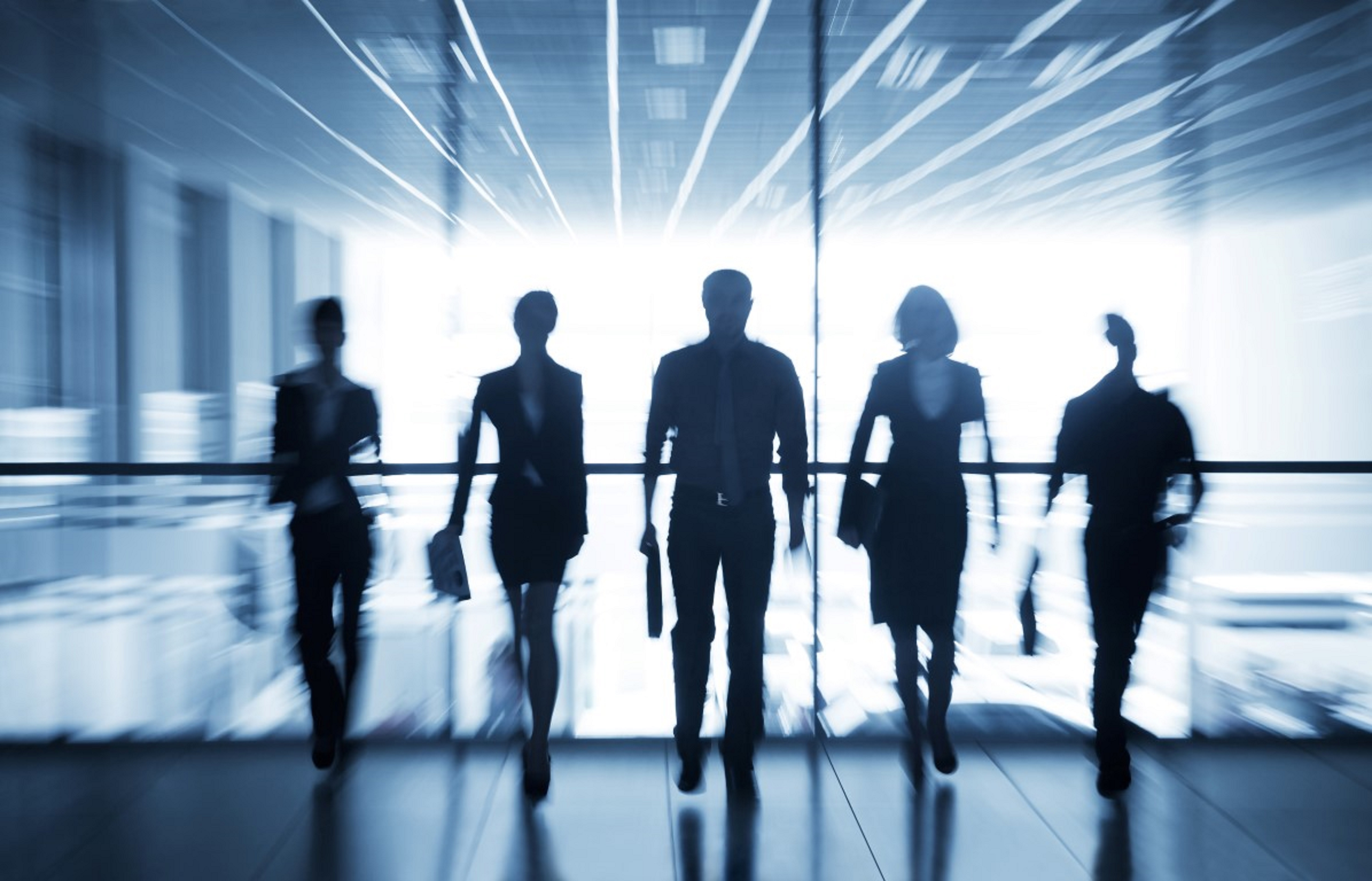 Several silhouettes of businesspeople interacting office background